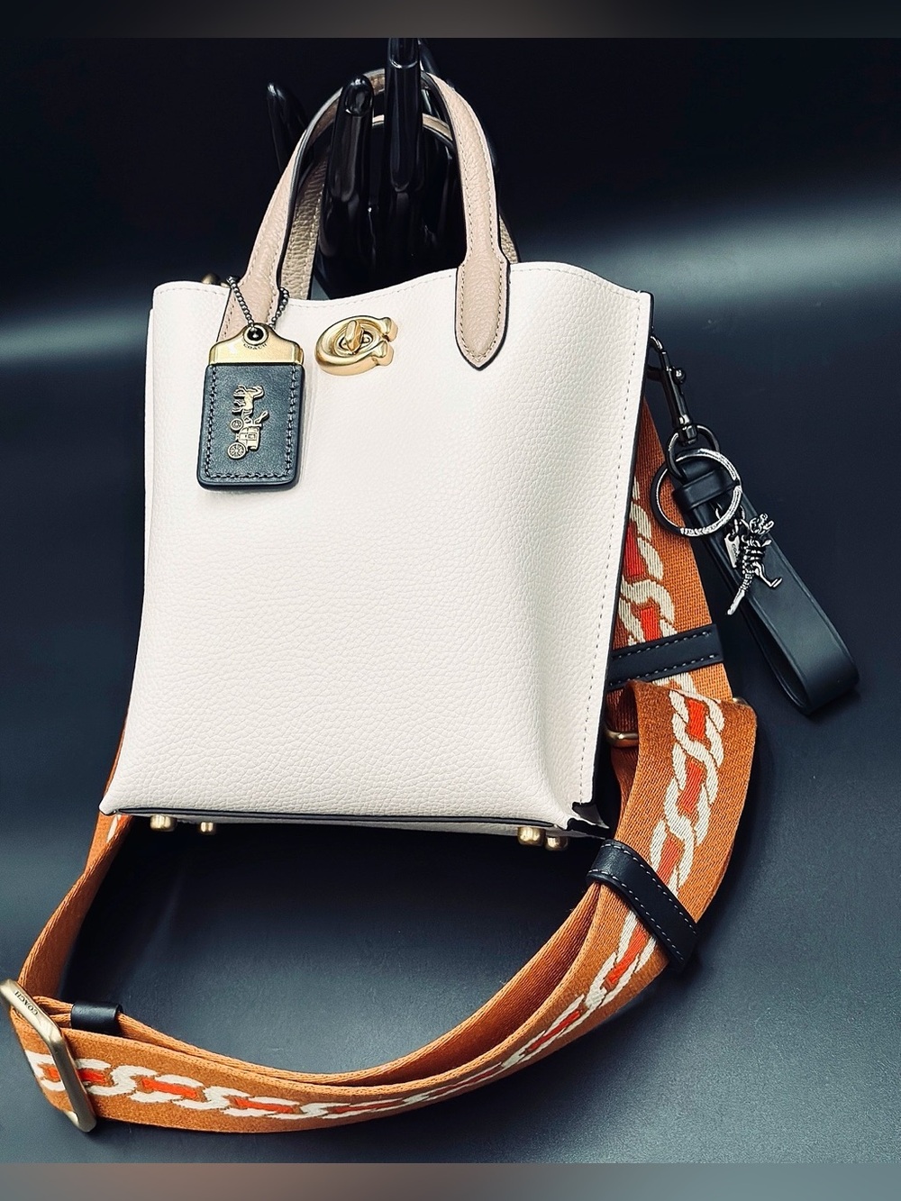 Coach Cream Pebbled Leather Tote with accessories.